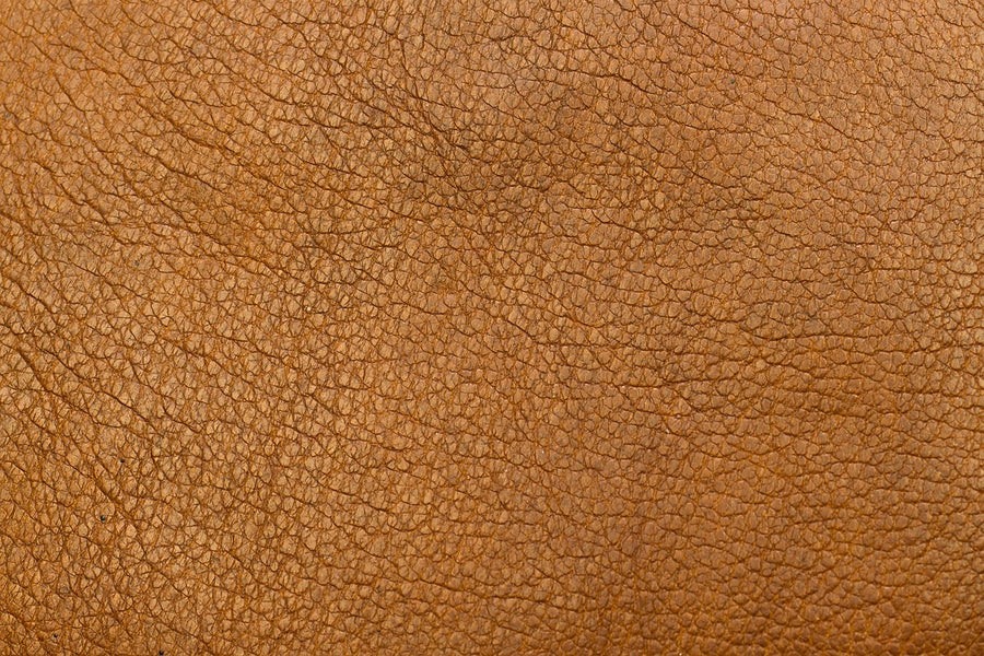 Close-up of brown grained leather showing the pebbled texture