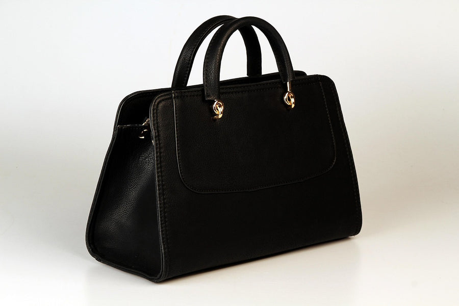 Black leather handbag photographed against a plain background