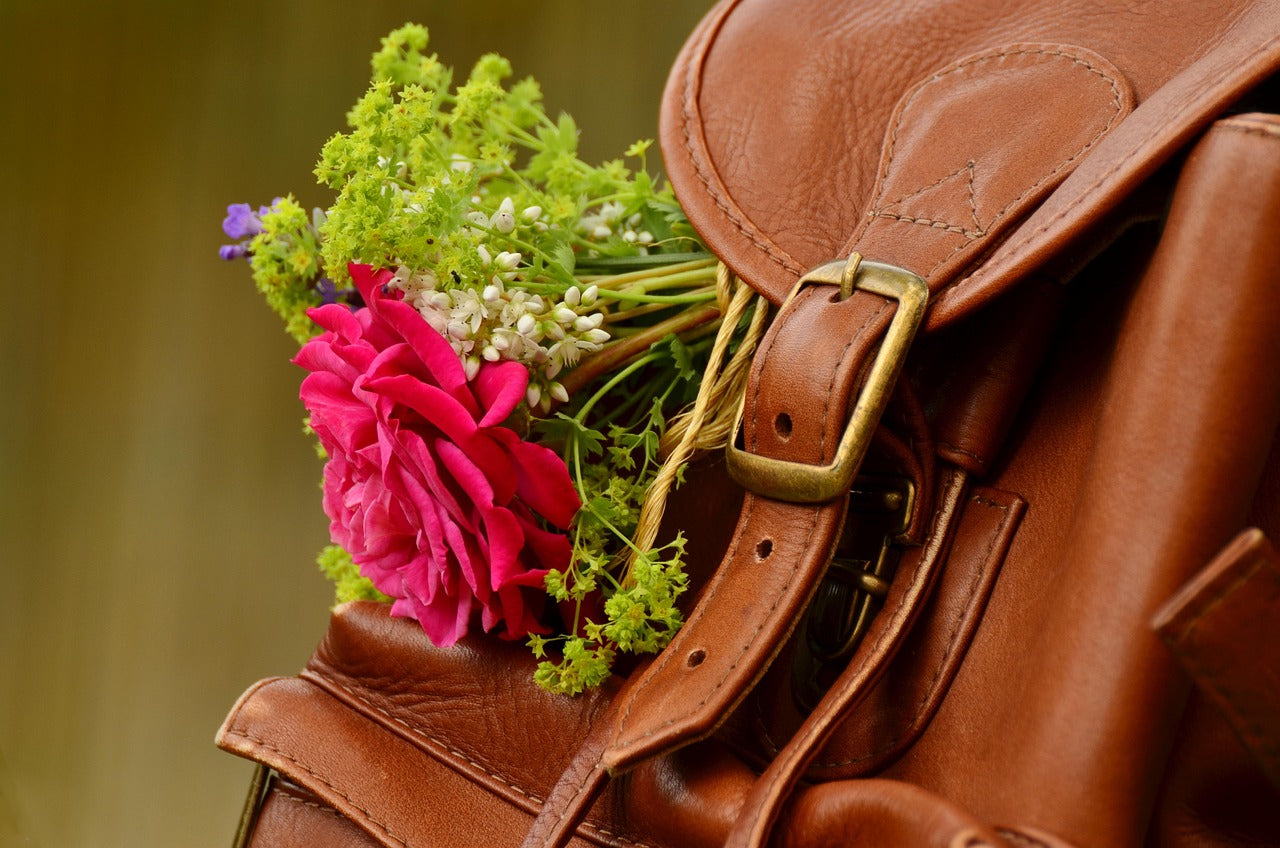 Brown full-grain leather backpack with brass buckles
