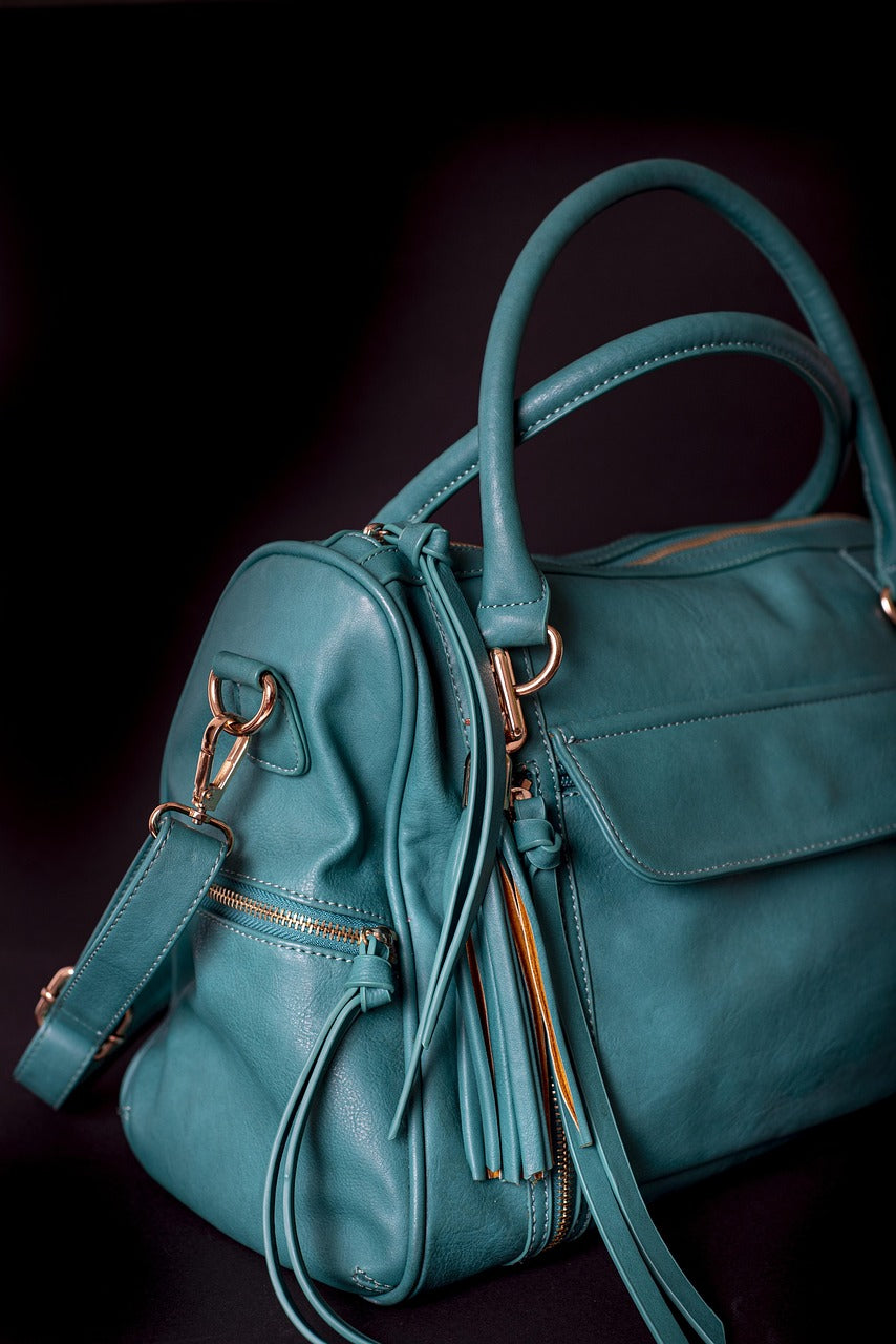 Green leather crossbody bag with a long adjustable shoulder strap